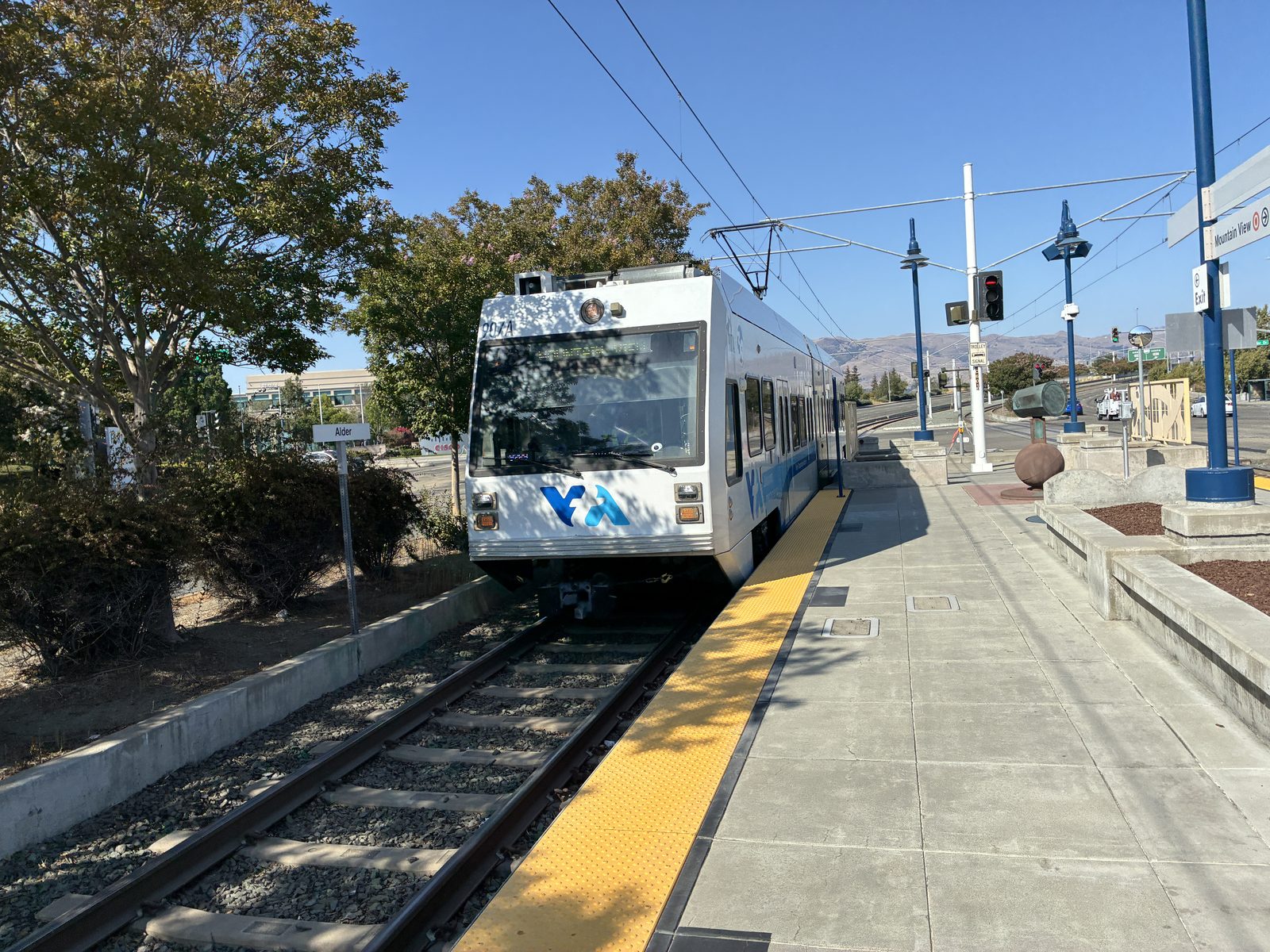 A VTA light rail car waiting at an empty open-air platform