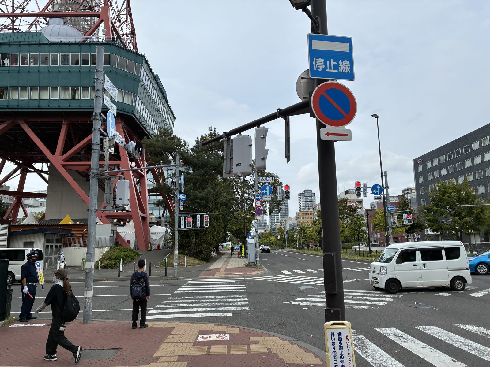 A crossing at the foot of the TV Tower, a few people waiting for the light