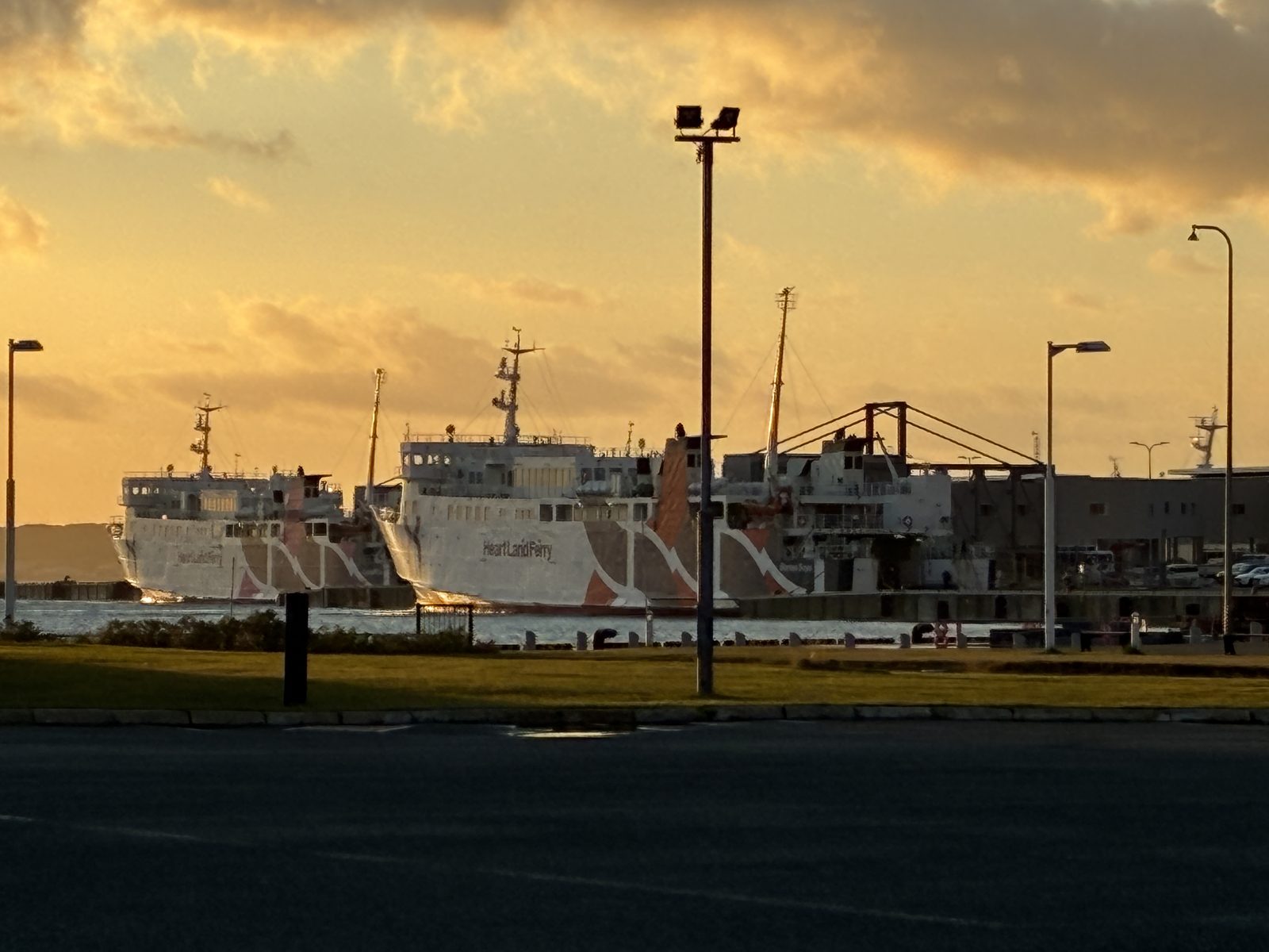 A ferry beneath golden morning clouds